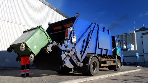 Skip hire vehicle being loaded in Downham eco-friendly waste disposal area